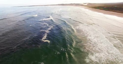 Aerial view of waves reaching a shore at beach