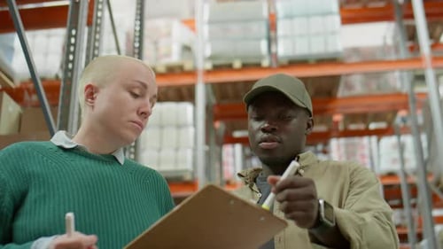 Multiethnic Managers Working in Warehouse