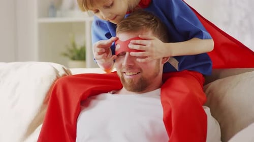 Girl Dresses Dad as Superhero at Home