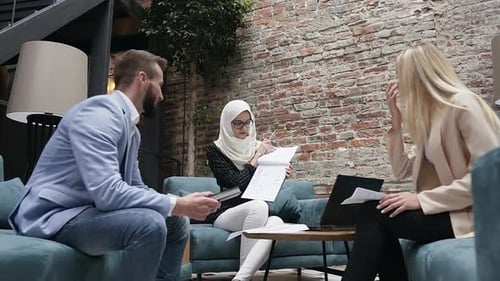 Muslim Female Leader Talking with Two Caucasian Coworkers, Briefing, Discuss Business Plan