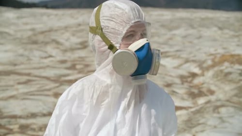 Person in Hazmat Suit on Barren Earth