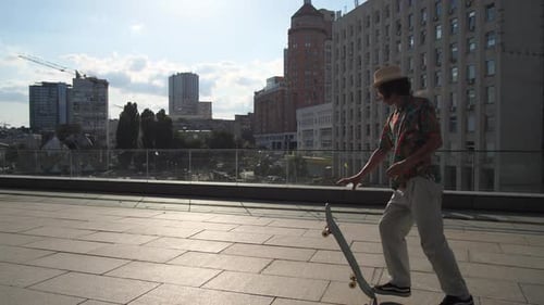Man Skater Picking Up Skateboard After Riding