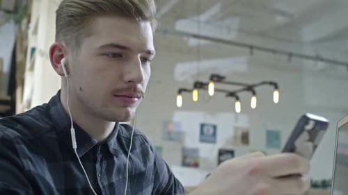 Young Adult Works in a Modern Office