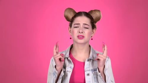 Worried Woman Pleading with Fingers Crossed