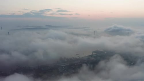 Drone View of the City Bay and Big Bridge Covered with Fog at Sunset