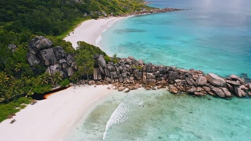Drone Aerial Circle Flight Above Granite Rocks and Azure Crystal Clear Ocean Water of Picturesque