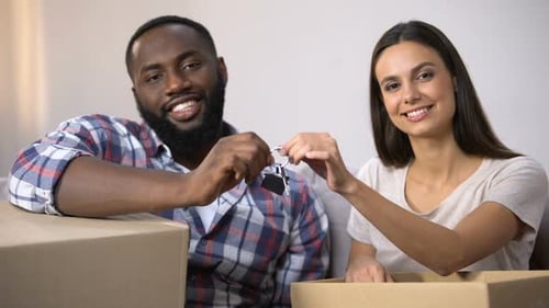 Happy Multiracial Couple Holding Carton Boxes and House Key Chain, Relocation