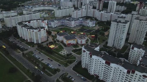 City block. Modern multi-storey buildings. Flying at dusk at sunset.