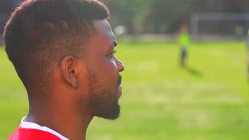 Brazilian Man Goalkeeper Catches the Ball in the Stadium During a Football Training
