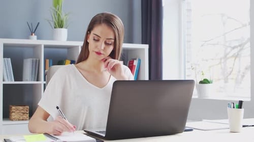 Young Woman Works at Home Office Using Computer.