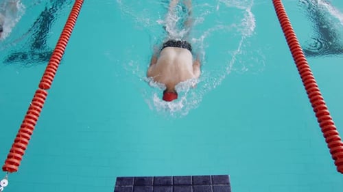 Swimmers swimming into the pool