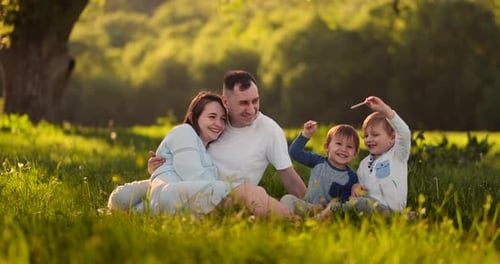 Happy Family Playing in a Sunny Field