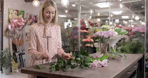 Woman Prepares Flowers at a Flower Shop