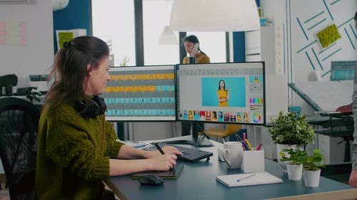 Woman Photo Editing Using Stylus in Modern Office