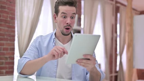 Young Adult Looking at Tablet with Varying Emotions