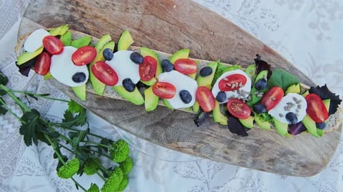 Delicious Sandwich with Avocado, Tomatoes, and Berries