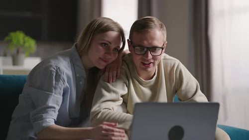 Loving Couple Video Chatting With Family Using Laptop