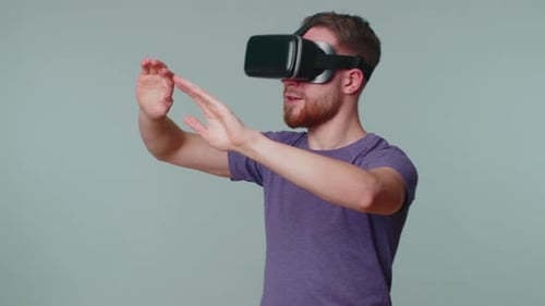 Young Man Wearing Virtual Reality Headset Interacting