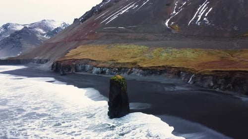 Ocean Coast in Iceland Waves Break on Rocks The Sea Erodes Volcanic Rocks Aerial View