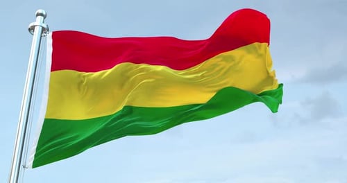 Realistic Red Yellow Green National Flag Waving in Blue Sky