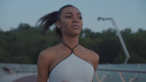 Athletic Woman Running on City Bridge