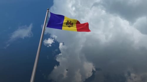 National Flag of Moldova Waving in Cloudy Blue Sky