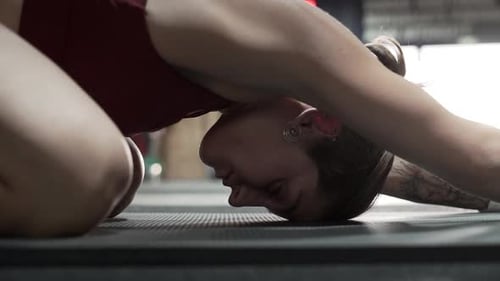 Sportswoman stretching in gym