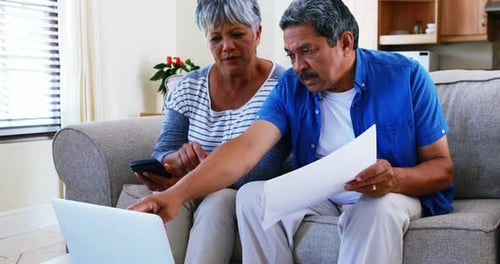 Mature Couple Reviewing Finances at Home Together