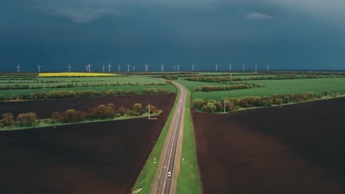 Aerial View of Highway with Wind Turbines