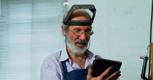 Goldsmith using digital tablet in workshop 4k
