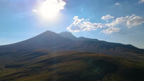 Sun Movement in Crystal Clear Sky with Clouds Over Mountain Top