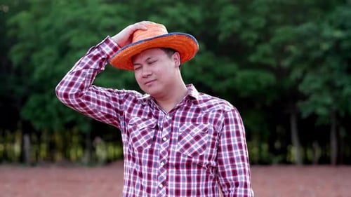 Asian adult standing smile farmer man happy looking to camera on cultivated area
