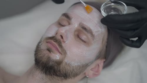 Man Receiving Facial Treatment at Spa