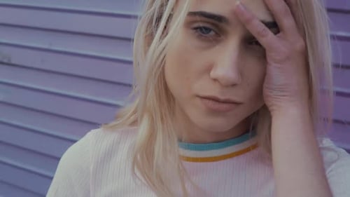 Close Up Of Young Woman Running Hand Through Hair
