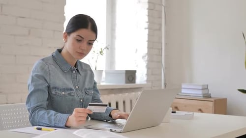 Woman Shopping Online with Credit Card at Home