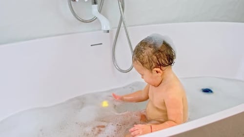 Adorable Infant Playing in a Bubble Bath
