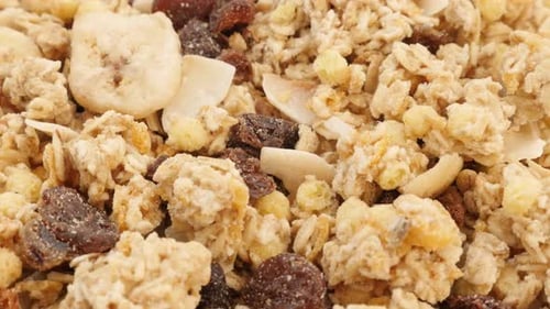 Raisins and other dried fruits in muesli crunch mix food background 4K 3840X2160 UltraHD tilting fo
