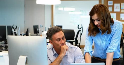 Business Professionals Collaborating on Computer in Office