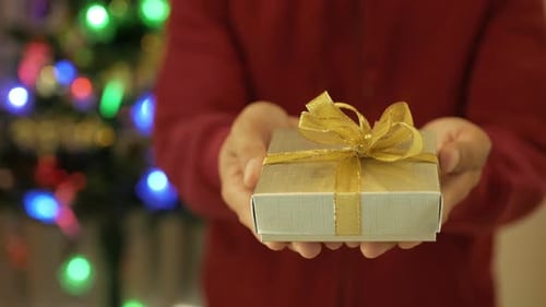 Presenting Christmas Gift with Festive Holiday Lights