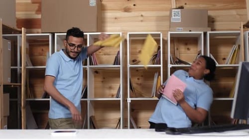 Excited Employees Throwing Mail at Workplace Celebration