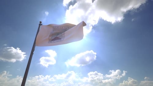 Realistic Waving Flag with Emblem Against Sunny Blue Sky