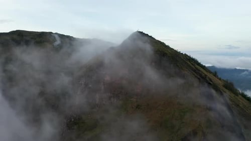 Aerial Truck Shot Flying Past the Mountain Top of an Active Volcano in Tropical Climate and