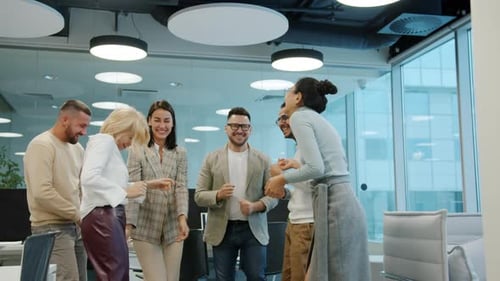 Happy Colleagues Male and Female Dancing in Shared Office Room Having Fun Indoors