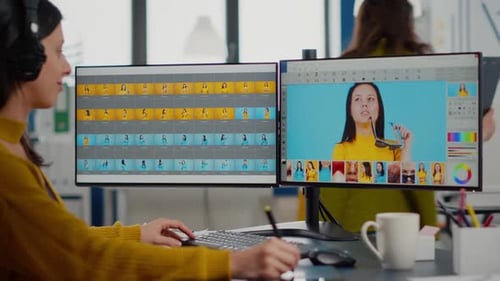 Woman Edits Images at Dual Monitor Workstation