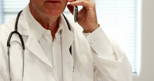Doctor Talking on the Phone in Clinical Setting