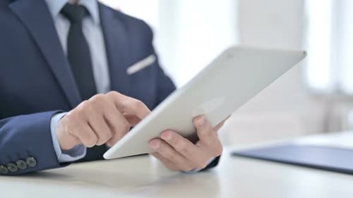 Businessman Typing Email on Tablet