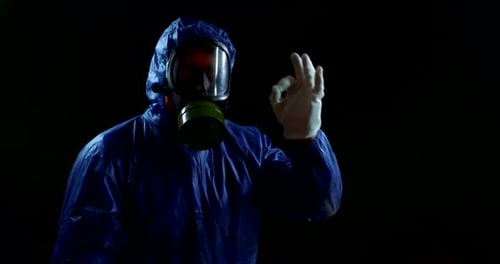 Person in Hazmat Suit Puts on Gloves