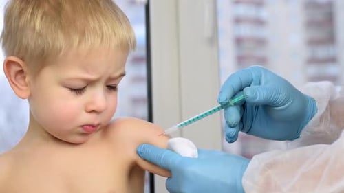 Child Getting an Injection from Medical Professional