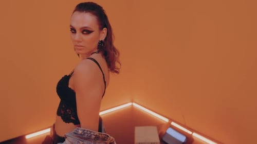 Stylish Young Woman Posing in Orange Room