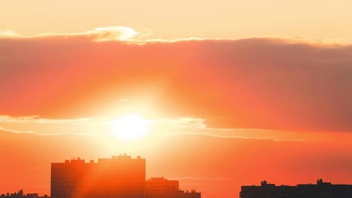 A time lapse video of a beautiful orange sunset in clouds